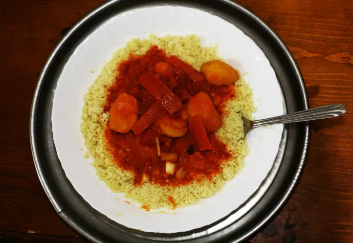 A white plate topped with rice and vegetables